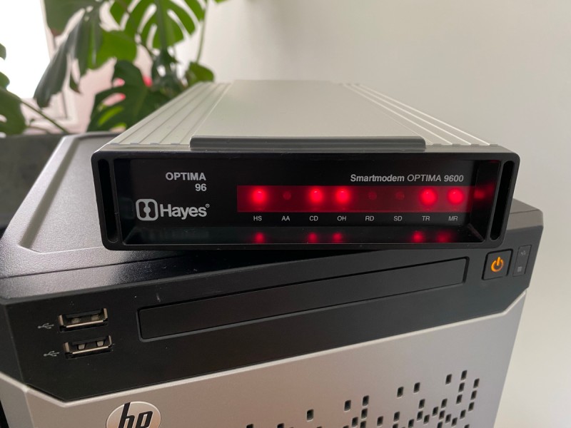 Picture of a converted Hayes Optima 9600 modem on top of a HP Microserver generation 8